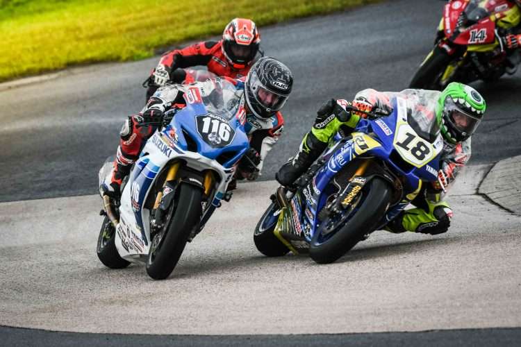 Early in the red flag interrupted CSBK Superbike Feature at Atlantic Motorsport Park in Nova Scotia back in 2019, Trevor Daley (Suzuki # 116) battles with “T.V. Tommy” Casas (Yamaha # 18) and BMW’s Jeff Williams on a damp track exiting the turn two hairpin.
CREDIT: Image courtesy Damian Pereira